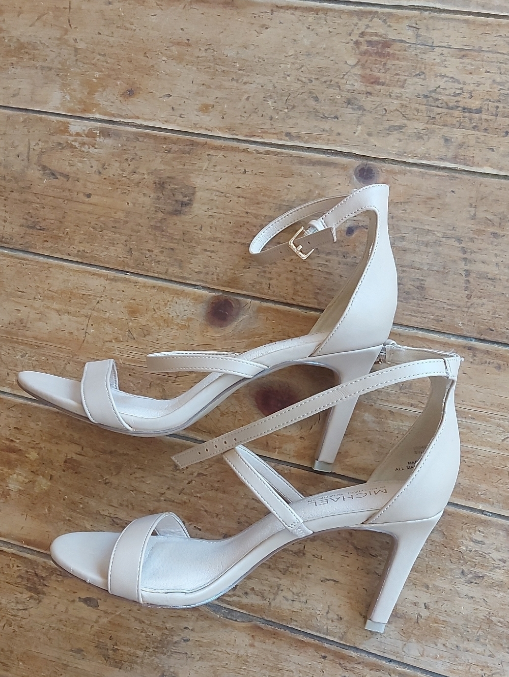 Cream-colored sandals from the brand Michael Shannon